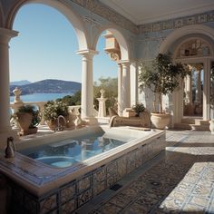 an indoor jacuzzi tub in the middle of a room with columns and arches