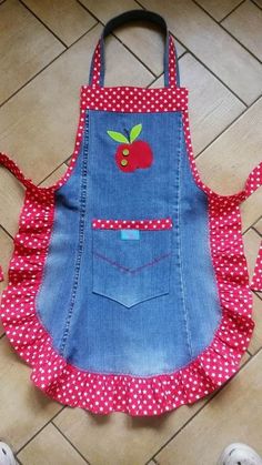 a child's apron with an apple applique on it