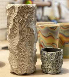 three ceramic cups sitting on top of a table