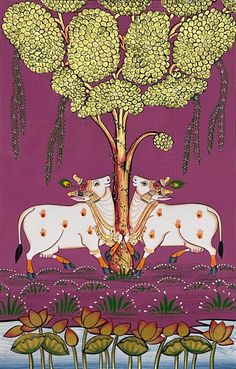 two cows standing under a tree in the middle of a field with flowers on it