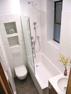 a bathroom with a sink, toilet and bathtub next to a window in it