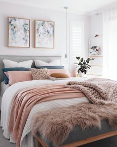 a bedroom with white walls and neutrals in the color scheme, including pink, gray,