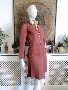 "☆ DESCRIPTION ☆ Beautiful vintage Biba skirt suit from 1969-70. Made from a tea rose colour sateen grosgrain fabric. The jacket is beautifully fitted with wide lapels, patch pockets, slim sleeves and a gathered feature on the back. Midi skirt is a subtle A-line shape. Both jacket and skirt are unlined so perfect for indoor wear.  ☆ CONDITION ☆ Excellent to very good vintage condition. Faults to note: there is a series of tiny dot-like pale marks in the fabric on the lower back and bottom (See last photo) and also some on the back of the right sleeve (see seventh photo). The original owner raised the hemline about 1.5 inches and I have left it \"as is\" since there is likely to be a visible line if lowered again. One of the buttons has the rim partly shear off (see eighth photo). The suit Retro Fitted Skirt Suit For Spring, Retro Fitted Skirt Suit, Vintage Tailored Skirt Suit For Spring, Tailored Vintage Skirt Suit For Spring, Turtleneck Suit, Biba Fashion, 60s Skirt, Vintage Skirt Suit, 70s Inspired Fashion