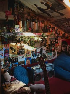 a room filled with lots of posters and guitars