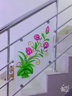 a glass painting on the side of a stair rail with flowers and leaves painted on it