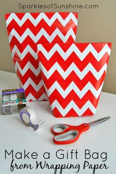 red and white chevron gift bags with scissors, tape, and other crafting supplies