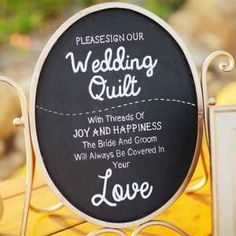 a chalkboard sign that says, wedding quilts with thread and happiness the bride and groom will always be covered in love