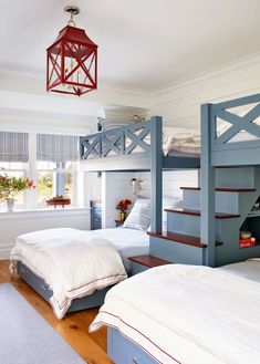 two beds in a room with blue and white bunk beds on top of each other