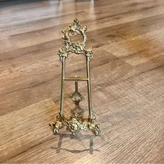 a small metal shelf sitting on top of a wooden floor