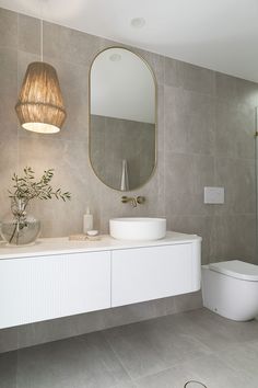 a bathroom with a sink, toilet and mirror