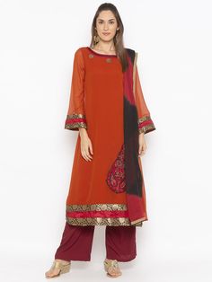 Rust Georgette A Line Kurta With Hand Embroidery On Front And Neckline.. Contrast Piping And Brocade Detailing On Neck ..Full Semi Bell Sleeves And Hemline Worn With Maroonish Culottes And Shaded Black Maroon Chiffon Dupatta With Gold Borders Around It. Salwar Suits Online, A Line Kurta, Chiffon Dupatta