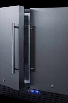 two stainless steel refrigerators side by side with blue lights on the front and bottom