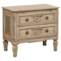 an old chest with two drawers on one side and gold knobs on the other