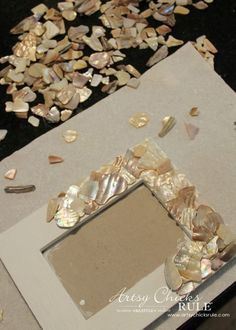 an old mirror with shells scattered around it