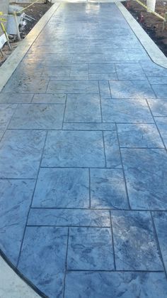 a blue stone walkway in front of a house