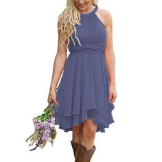 a woman in a green dress holding a bouquet of flowers and wearing brown cowboy boots