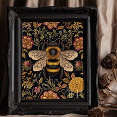 a painting of a bee on a black background with flowers and leaves in the frame