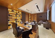 an office with wood paneling and leather chairs