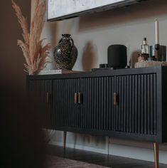 a black cabinet with some candles on it