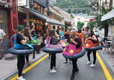 some people are walking down the street with floats