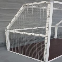 a large white cage with metal bars on the sides