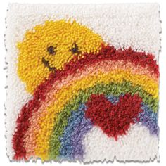 a multicolored rug with a teddy bear on it's side and a rainbow in the middle