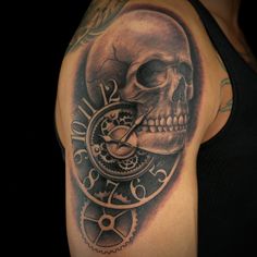 a skull with a clock on it's side and gears in the back tattoo