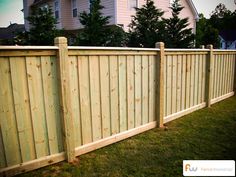 a wooden fence in front of a house