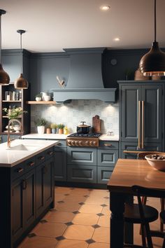 a kitchen with blue cabinets and an island in front of the stove top is lit by two pendant lights