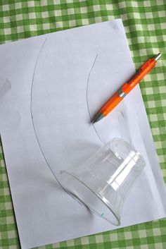 a piece of paper that has been cut out and is sitting on a table with a pen