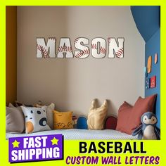 a baseball themed bedroom with the name mason on the wall next to it and stuffed animals