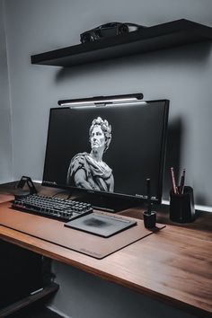 a computer monitor sitting on top of a wooden desk next to a keyboard and mouse