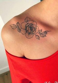 a woman with a rose tattoo on her shoulder