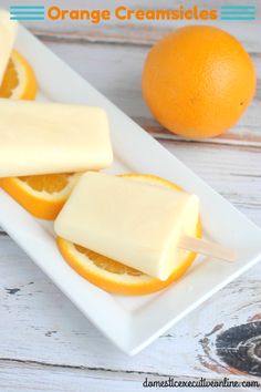 orange creamsices on a white plate with an orange in the background and text overlay that says orange creamsices