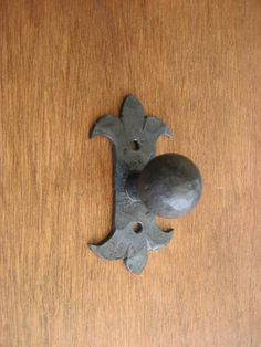 an iron door handle on a wooden door