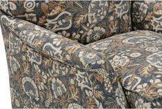 an upholstered chair with a floral pattern on the armrests and back