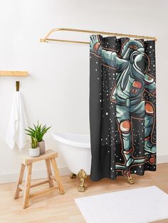 an astronaut shower curtain hanging in a bathroom next to a bathtub with a wooden stool