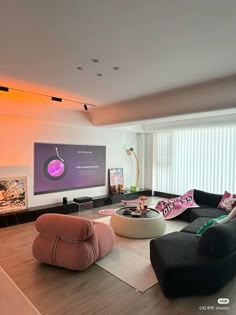 a living room filled with lots of furniture and a flat screen tv mounted on the wall