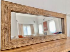 a mirror sitting on top of a wooden table