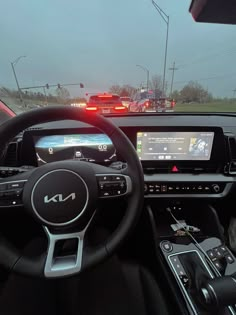 the interior of a car with dashboard, steering wheel and dash lights in front of it