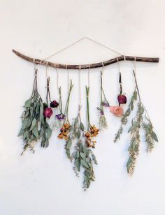 flowers are hanging on a wall with the words diy floral wall hanging