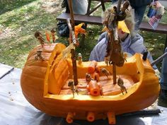 a pumpkin boat filled with lots of little bugs