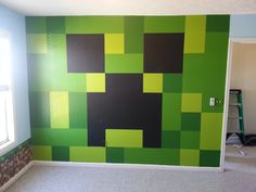 a room with green and black squares painted on the wall