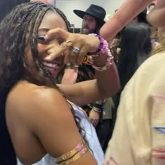 a woman with dreadlocks standing in front of other people