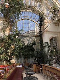 the inside of a building with many tables and chairs