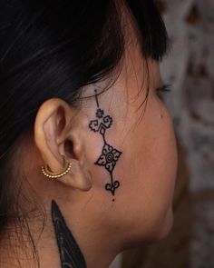 a woman with a cross tattoo on her neck