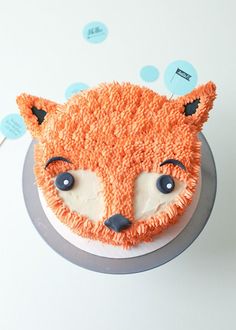 a cake decorated like a fox on top of a table