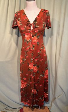 This is a cute vintage dress from the 60s. No brand labels. Tagged a size 14. The bust measures 34", empire waist 28", hip 38", see measurements below. I would say this is a Junior size.  Made of a soft, brushed cotton blend in rust brown and orange. It is an empire waist maxi dress. It is short sleeve.  No pockets. It has a keyhole opening in the center of the bust with drawstrings. About ankle length. Zips in the back with a metal zipper.   The dress is in good vintage condition. No damage.  No soil or stains.   Cute!  Measurements were taken with the garment lying flat and without stretching. If you have never worn vintage before, please measure yourself or a similar garment that fits you well & compare the measurements to these.  Vintage sizes run smaller than today's sizes, you need t Vintage Rayon Summer Dresses, Vintage Rayon Dresses For Summer, Vintage Fitted Maxi Dress With Short Sleeves, Fitted Casual Dress For Vintage Fashion, Retro Fitted Rayon Dresses, Fitted Vintage Midi Dress With Empire Waist, Vintage Retro Dress With Empire Waist, Vintage Fitted Midi Dress With Empire Waist, Vintage Fitted Midi Dress With Floral Print