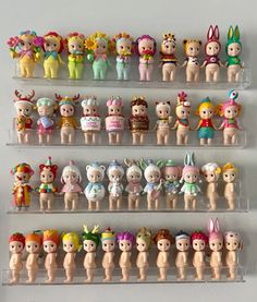 there are many small toy figures on the shelfs in this room, each with different outfits and hair colors