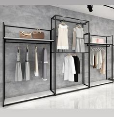 a clothing rack with clothes and handbags hanging on the wall in front of it